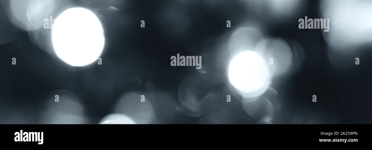 Blurred lights, gray, deep blue background, banner texture. Abstract bokeh with soft light header. Wide screen wallpaper. Panoramic web banner with co Stock Photo