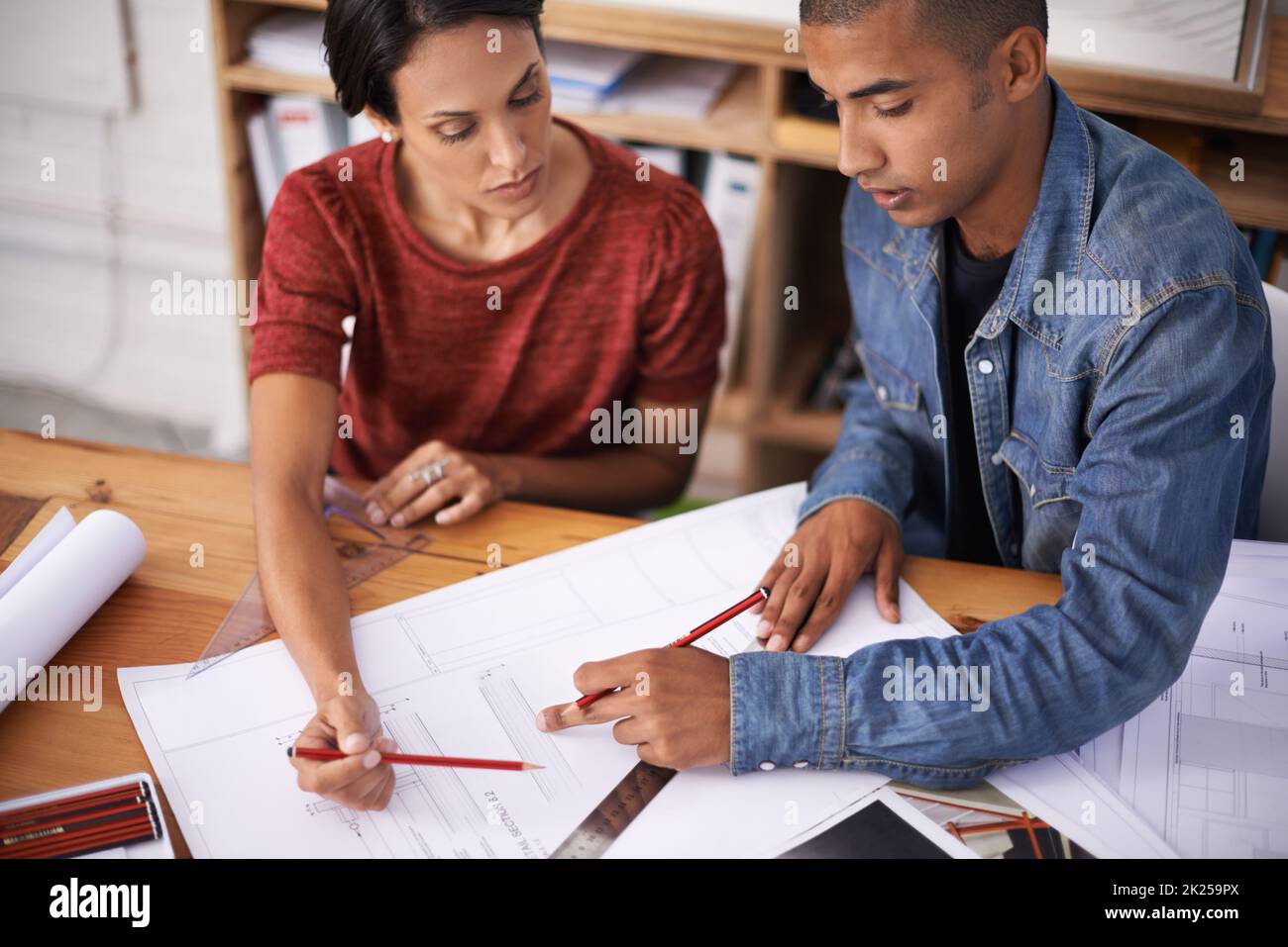 Ensuring quality in their design. two young designers working together in an office. Stock Photo