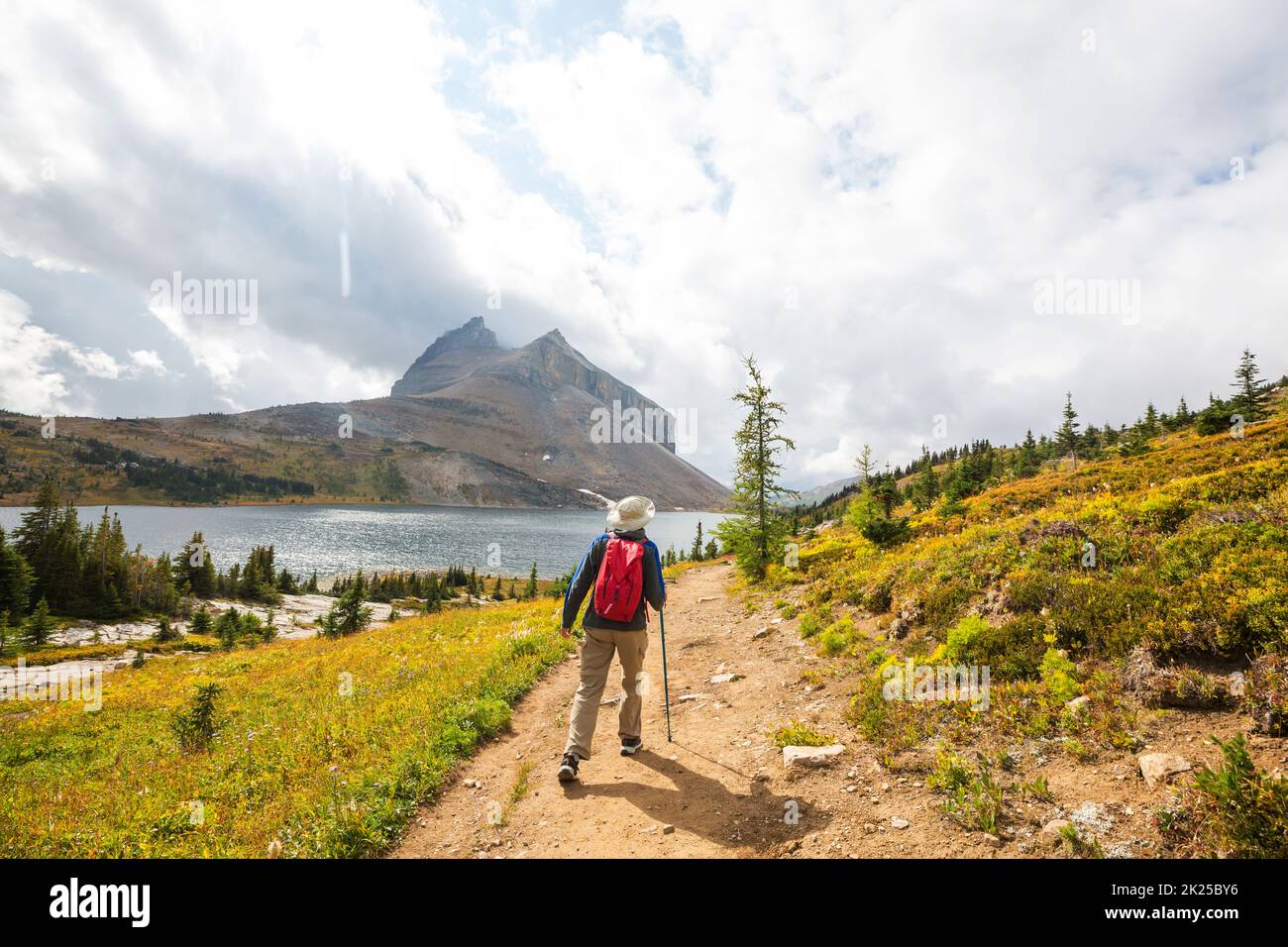 Hiking man in Canadian mountains. Hike is the popular recreation activity in North America. There are a lot of picturesque trails. Stock Photo