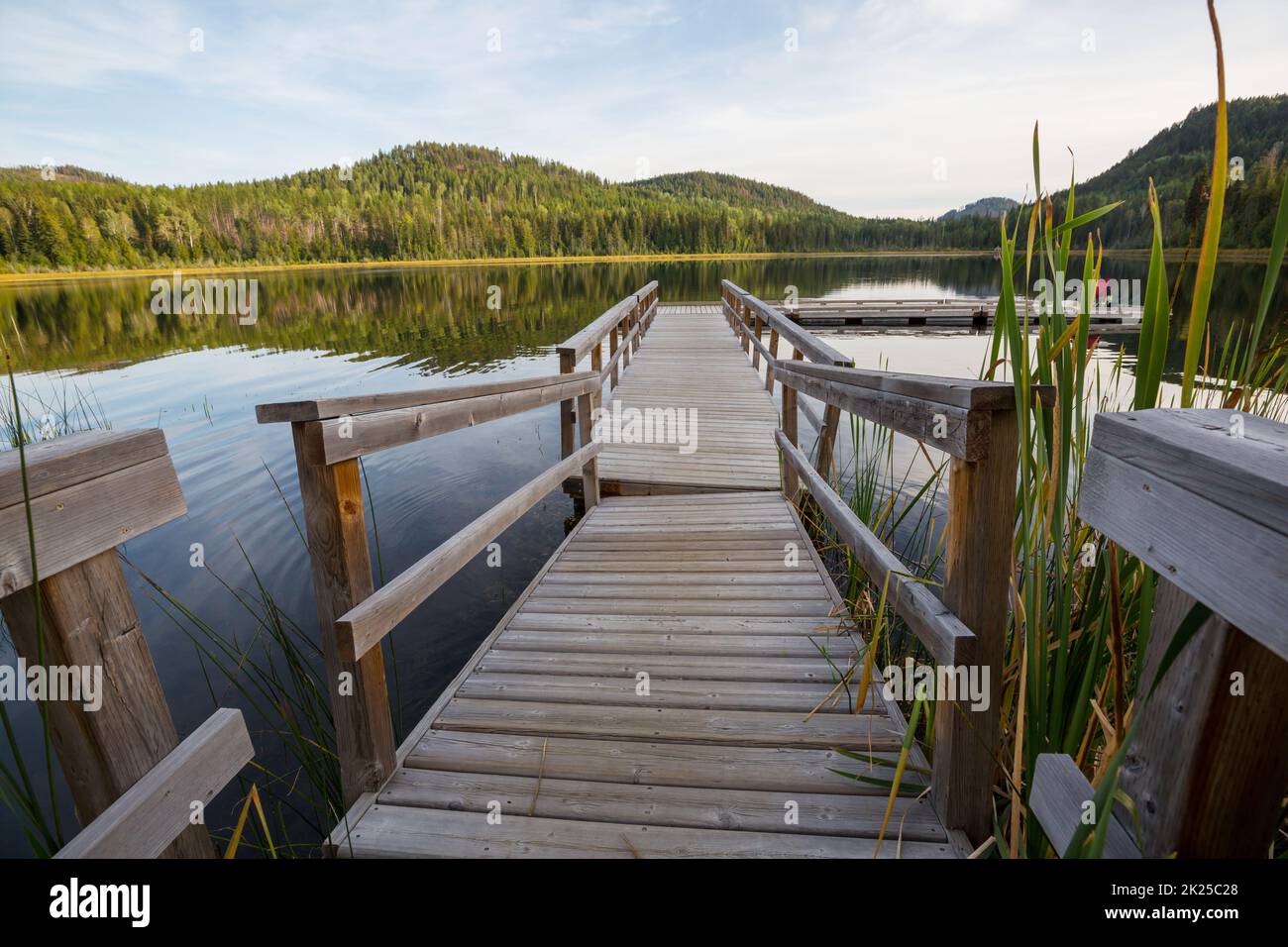 Wooden pier in serenity mountains lake Stock Photo