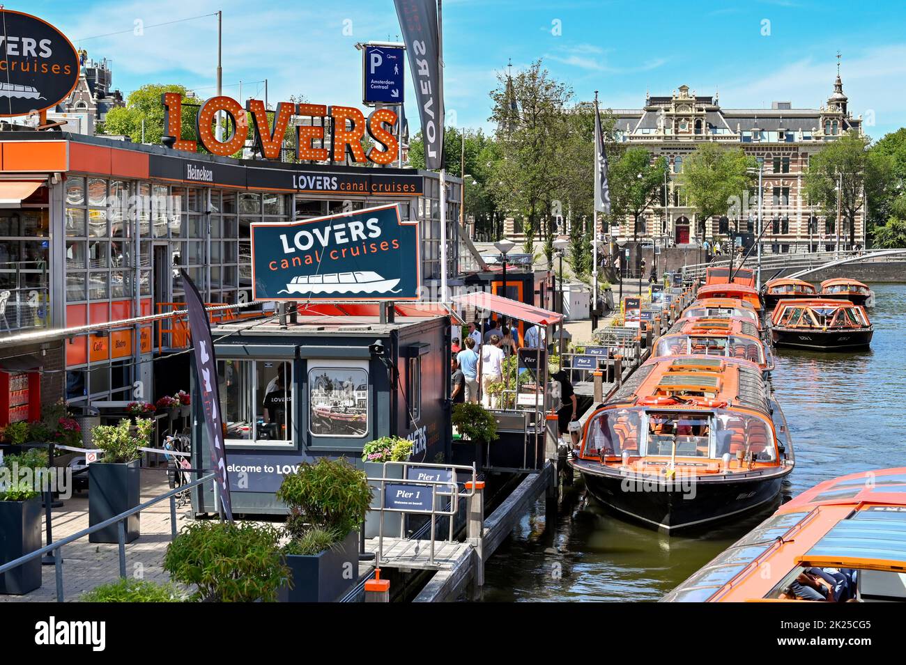 Amsterdam, Netherlands - August 2022: Tourist sightseeing canal boats moored at one of the piers in the city centre Stock Photo