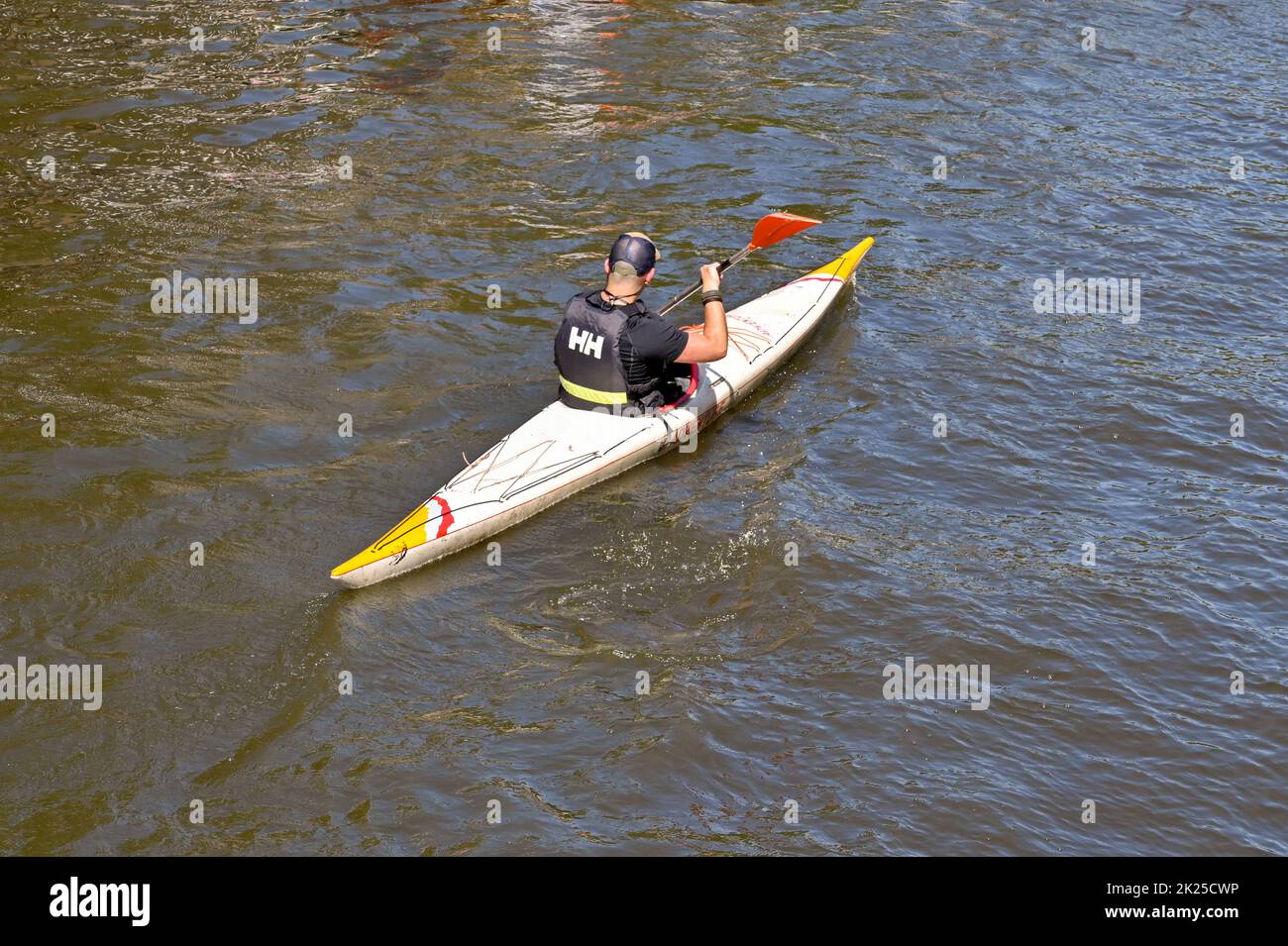 Amsterdam, Netherlands - August 2022: Person paddling a kayak on one of the city's canals Stock Photo
