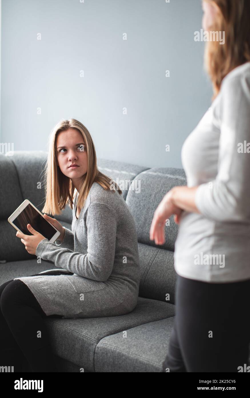 Screen time fight - teenage daughter unhappy about her mother limiting her screen time on a tablet computer Stock Photo