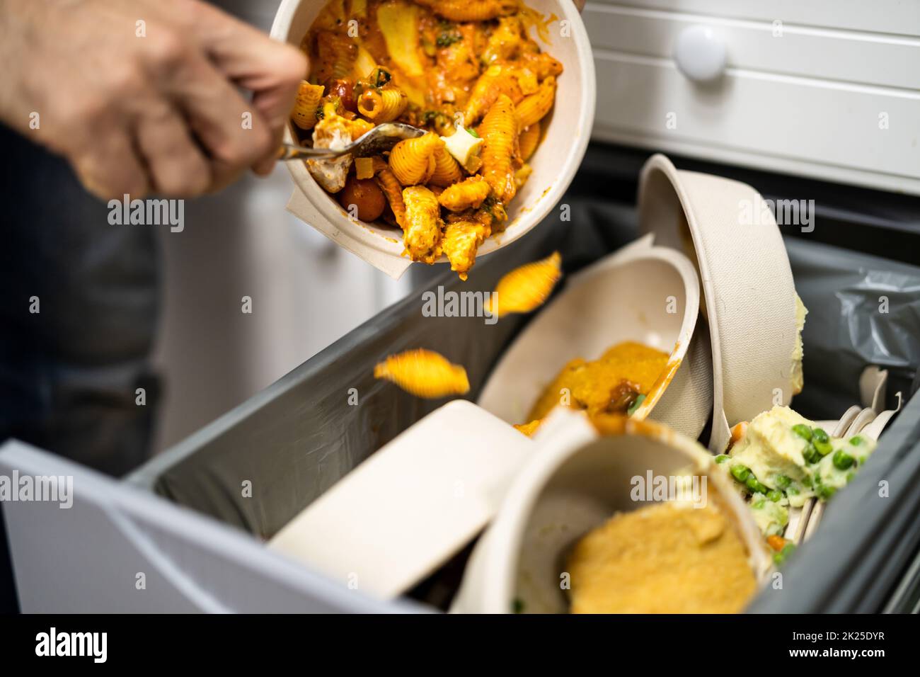 Throwing Away Leftover Food In Trash Stock Photo Alamy