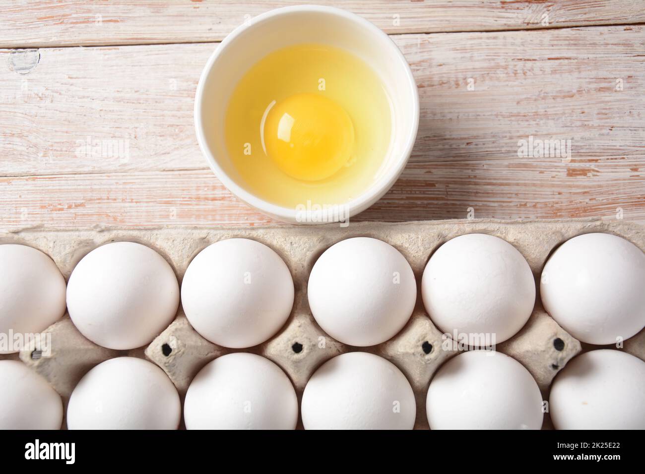White eggs and egg yolk .Store bought chicken eggs in gray carton Stock