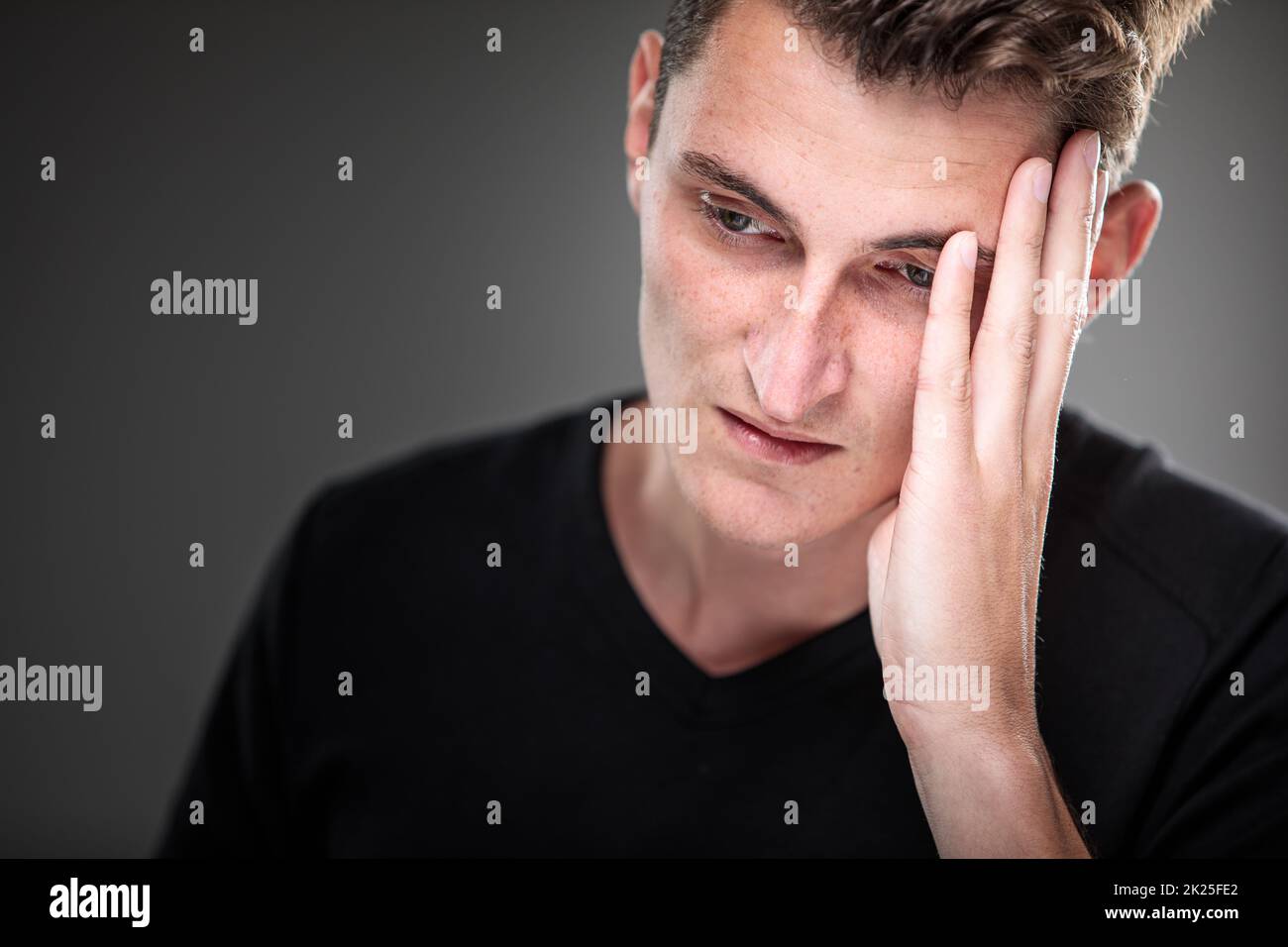 Fear/anxiety/regret/uncertainty in a young man - effects of a difficult life situation - vivid emotions concept Stock Photo