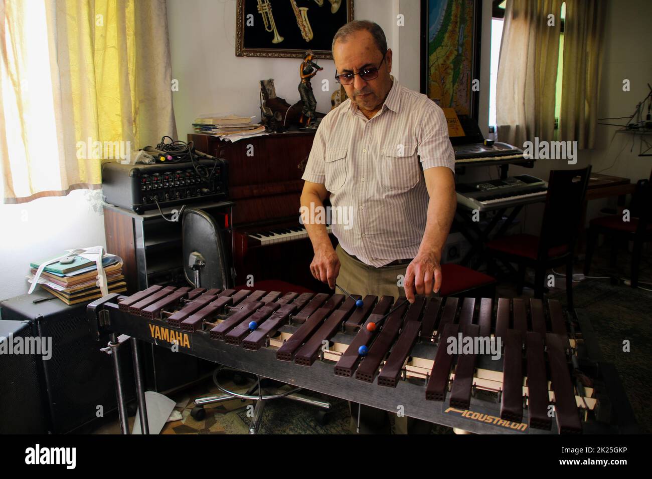 Gaza City, Gaza Strip, Palestine. 21st Sep, 2022. Gaza, Palestine. 21 September 2022. The director of the Gaza School of Music, Ibrahim Saleh Al-Najar, plays Middle Eastern and Western instruments at the institute in Gaza City. The school, which was established in 1997 and is the oldest music institute in the Gaza Strip, offers an important outlet to many young Palestinians who can pursue their music talent and express their emotions and creativity amid the challenges of living in the blockaded Palestinian enclave (Credit Image: © Ahmad Hasaballah/IMAGESLIVE via ZUMA Press Wire) Stock Photo