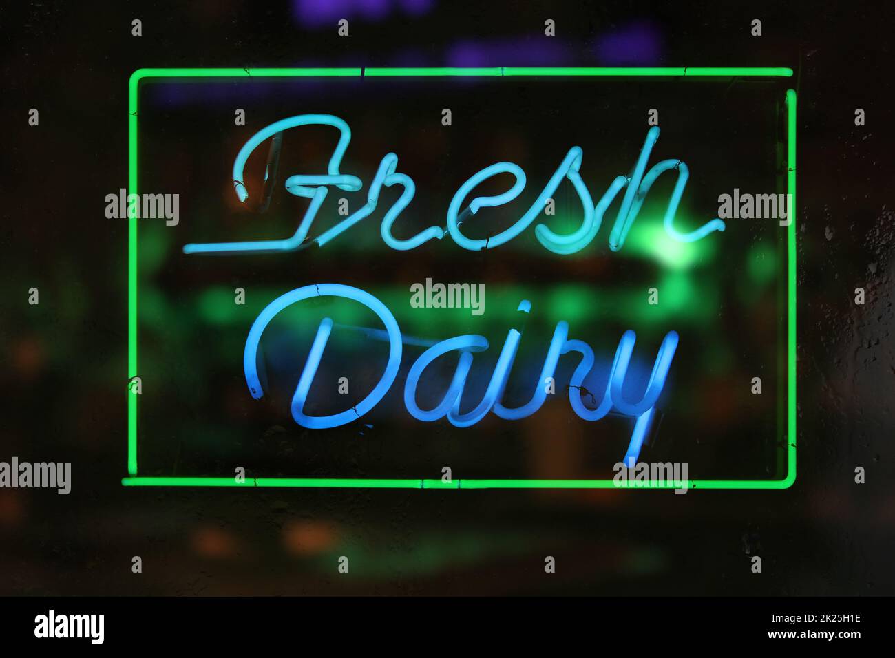 Photo of Vintage Fresh Dairy Neon Sign in a Rainy Window Stock Photo