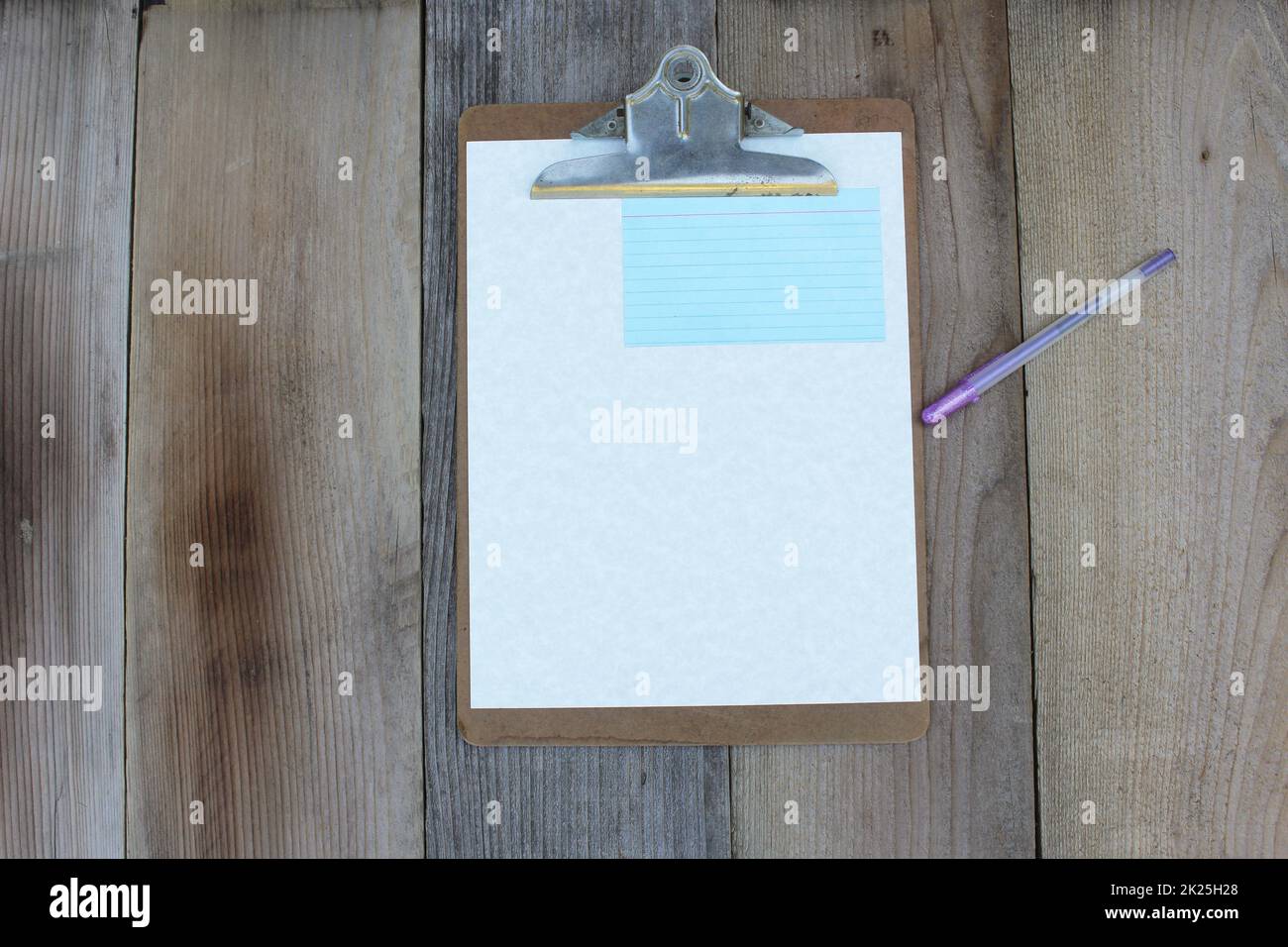 Clipboard With Blank Sheet of Paper on Wooden Table Stock Photo