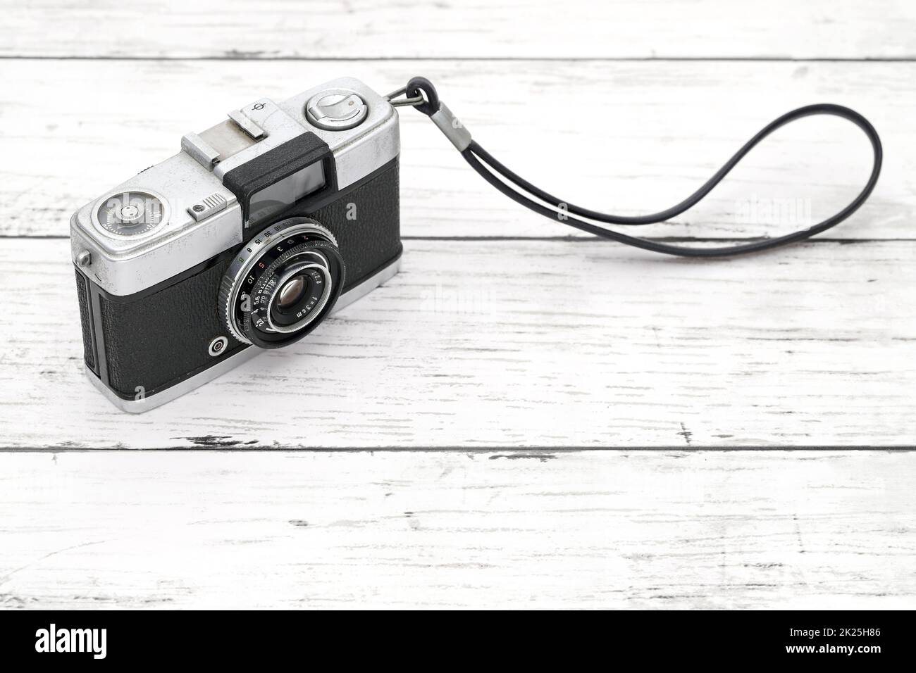 old film camera on a white wooden background Stock Photo