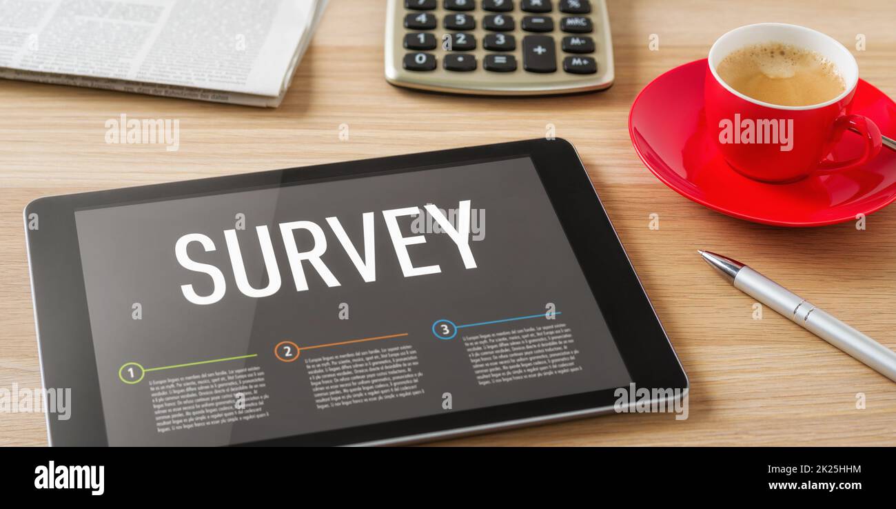 A tablet on a desk with the headline Survey Stock Photo