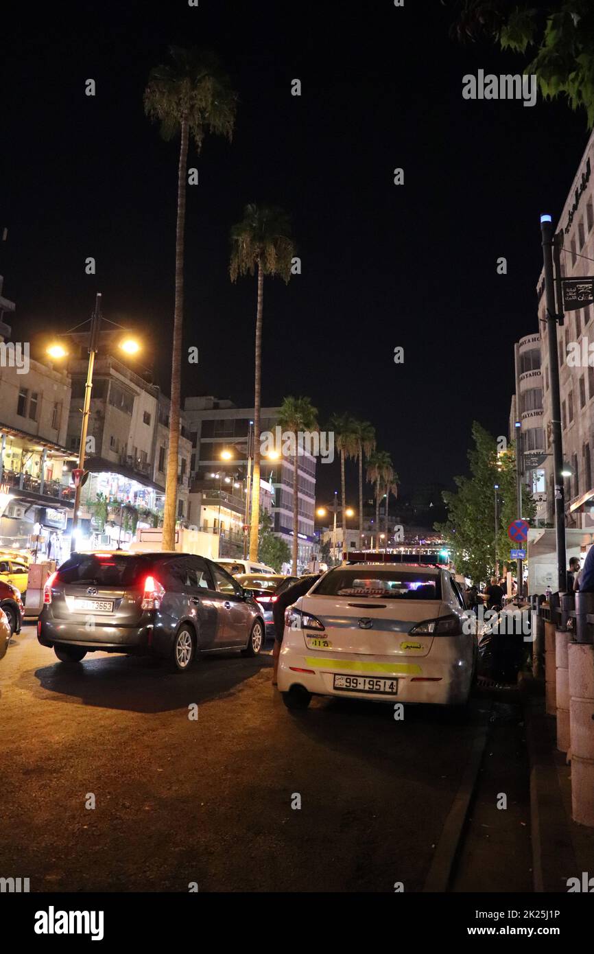 Amman, Jordan Downtown streets at night and a police car (the tallest palm tree Stock Photo