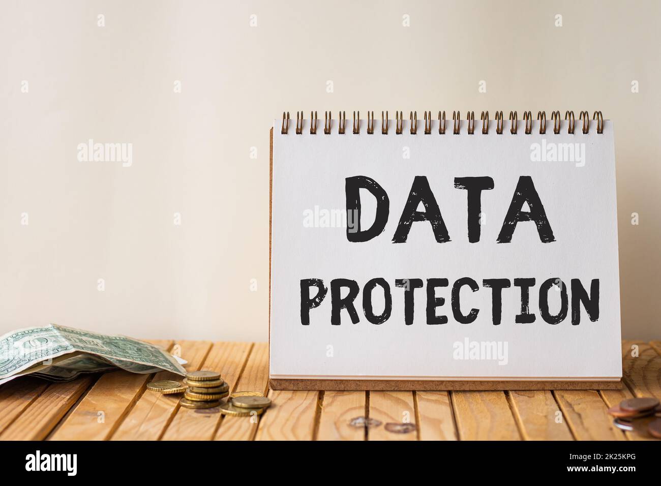 Text showing inspiration Data Protection. Word Written on Protect IP addresses and personal data from harmful software Empty Open Spiral Notebook Beside Stockpile Of Coins On Top Of Desk. Stock Photo