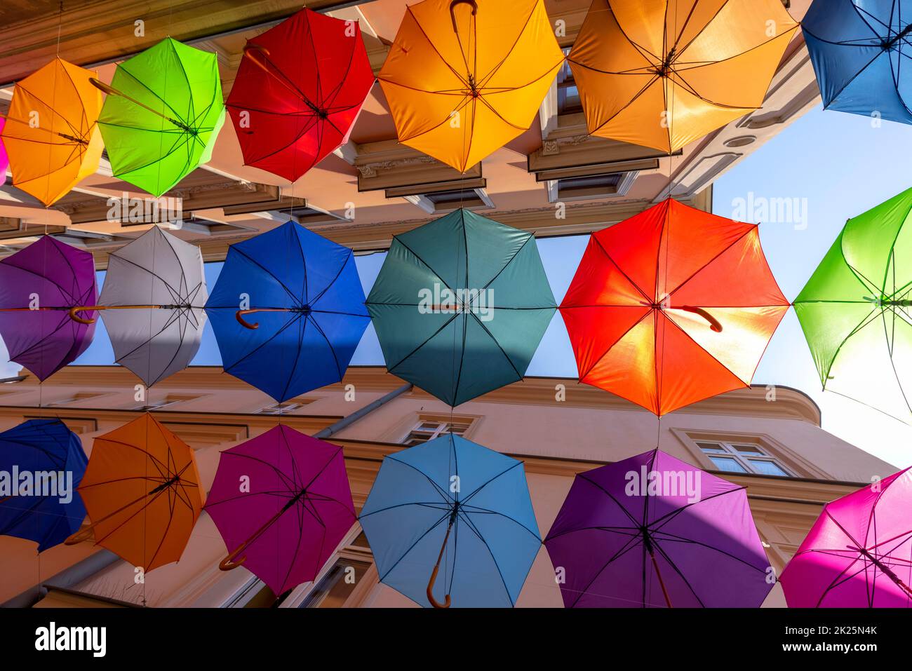 Colorful decorative umbrellas hanging over Piekarska street near Town Square, Tarnow, Poland Stock Photo