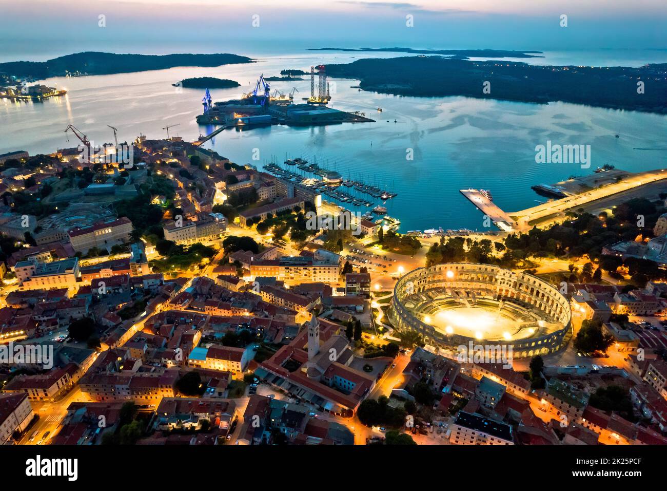 Arena Pula. Ancient Roman amphitheatre and bay of Pula aerial evening view Stock Photo