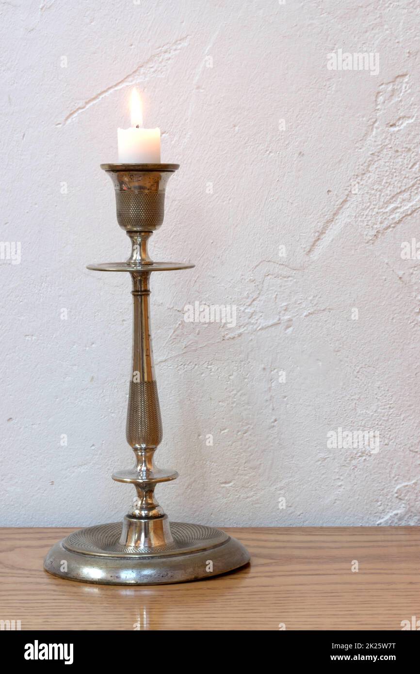 Old silver candlestick with candle Stock Photo Alamy