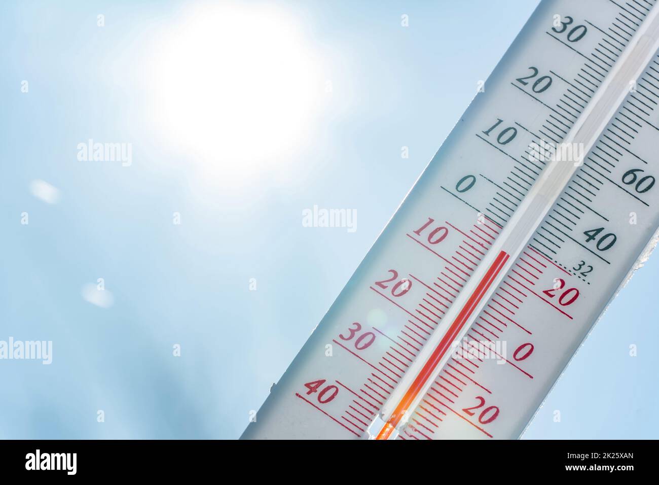 Thermometer in winter in the cold on snow and analyzes low negative air temperatures in clear sunny weather.Meteorological conditions and environmental analysis.Climate change on earth.Northern region Stock Photo