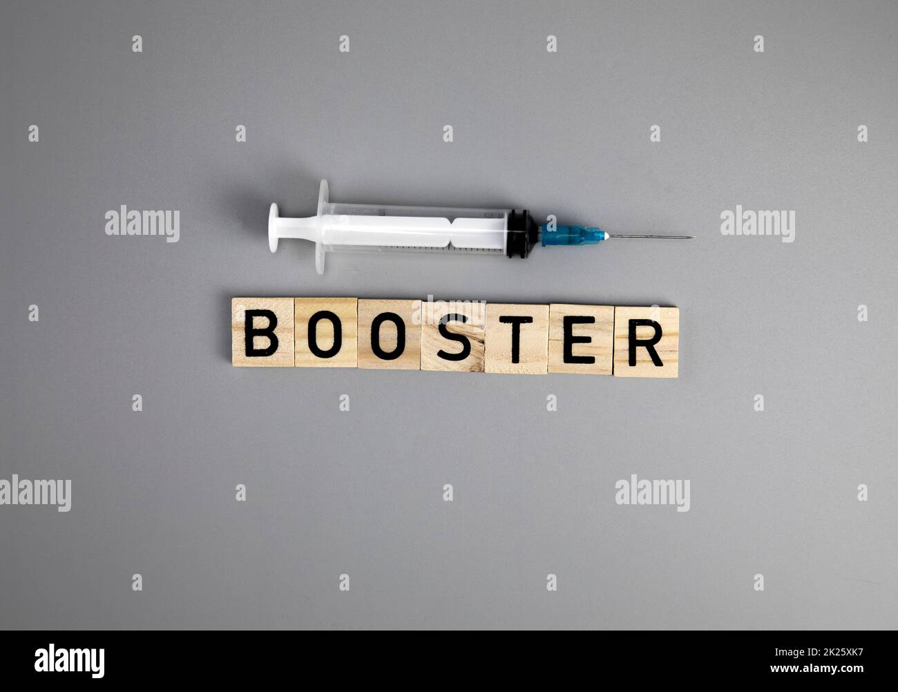 Covid-19 booster shots vaccine text on Gray background Covid-19 booster shots, with syringe top view and copy space , medical health,pandemic and vaccine concept. Stock Photo