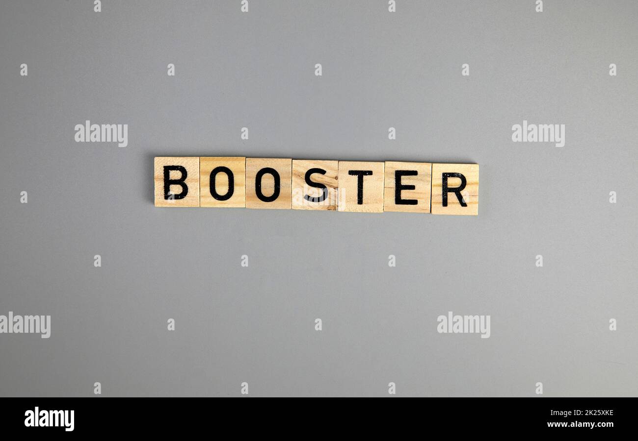Covid-19 booster shots vaccine text on Gray background Covid-19 booster shots, with syringe top view and copy space , medical health,pandemic and vaccine concept. Stock Photo