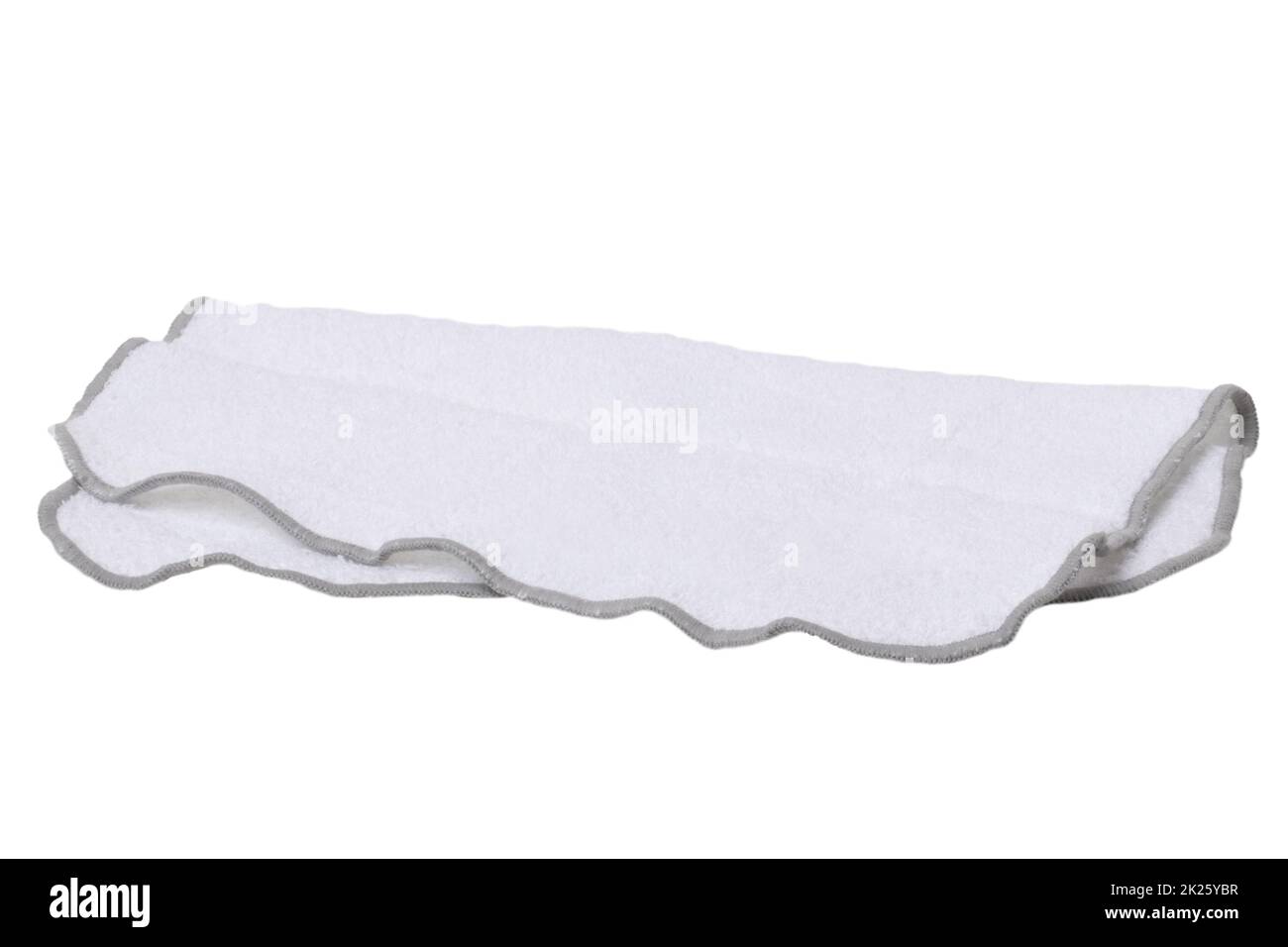 Household cleanliness and hygiene. Close-up of a white cleaning cloth isolated on a white background. Microfiber cleaning cloth. Macro. Stock Photo