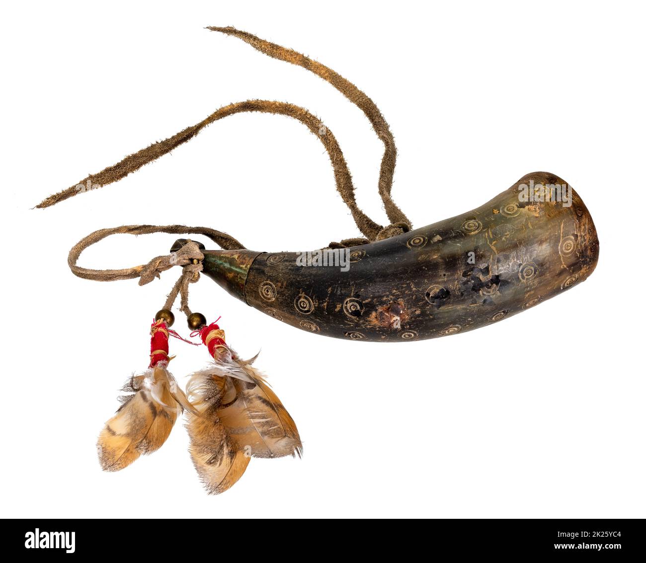Old powder horn of the North American Indians made of horn decorated with deerskin and feathers Stock Photo