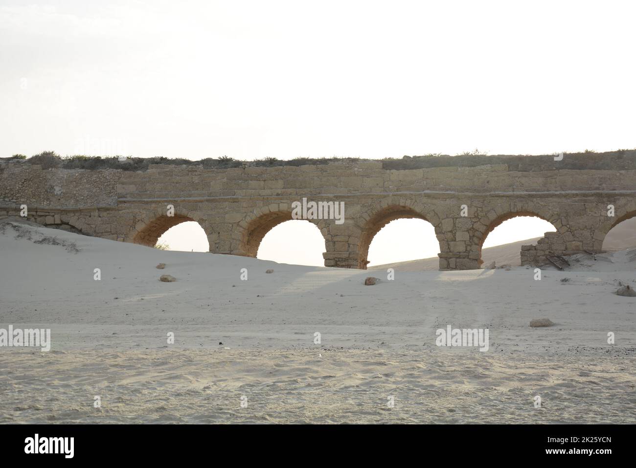 An old high level aqueduct. The remains of the Herodian aqueduct near the ancient city of Caesarea, Israel. Stock Photo
