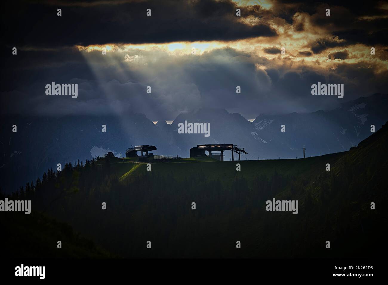 The sun is fighting against the clouds. This picture is taken in the morning on the top of a mountain in Austria. Stock Photo