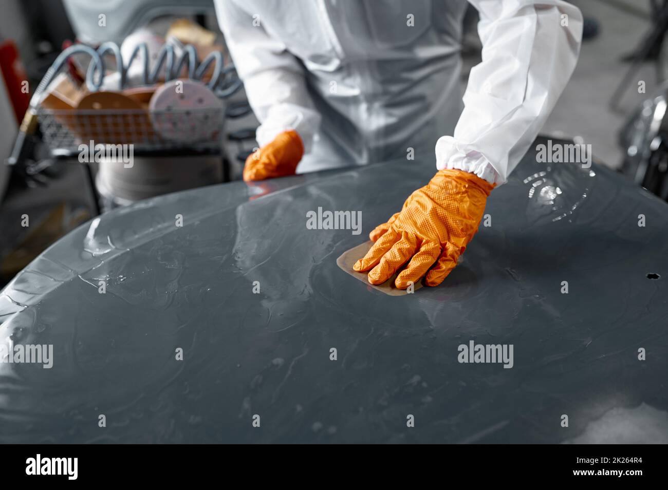 Mechanic in uniform sanding painted car body Stock Photo Alamy