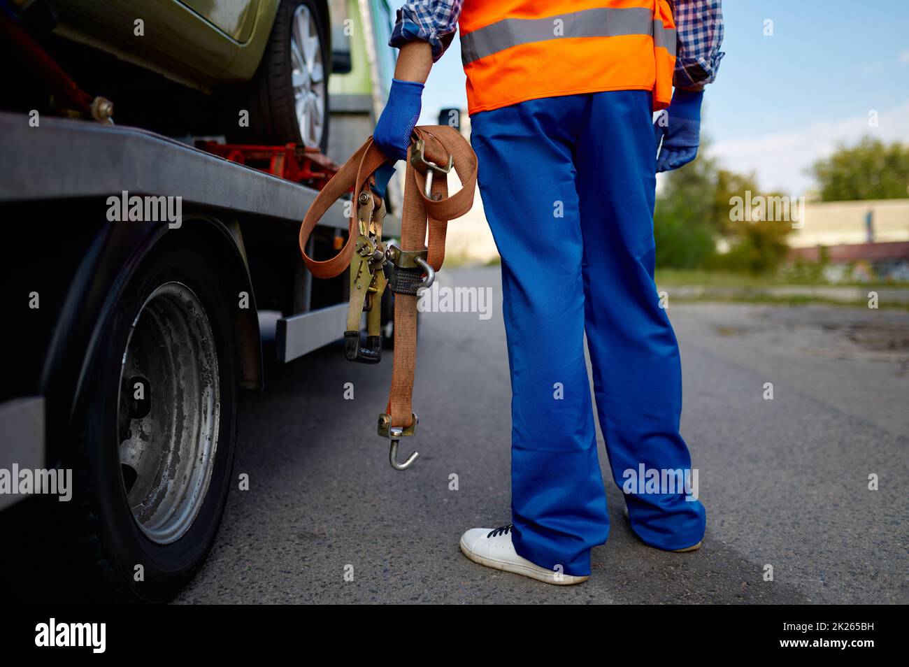 Male tow truck assistant holding fastening belts Stock Photo
