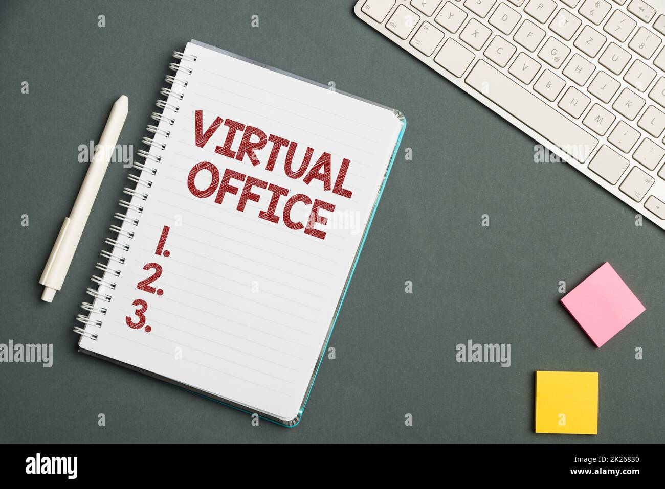Sign displaying Virtual Office. Business approach operational domain of any business or organization virtually Keyboard Over A Table Beside A Notebook And Pens With Sticky Notes Stock Photo