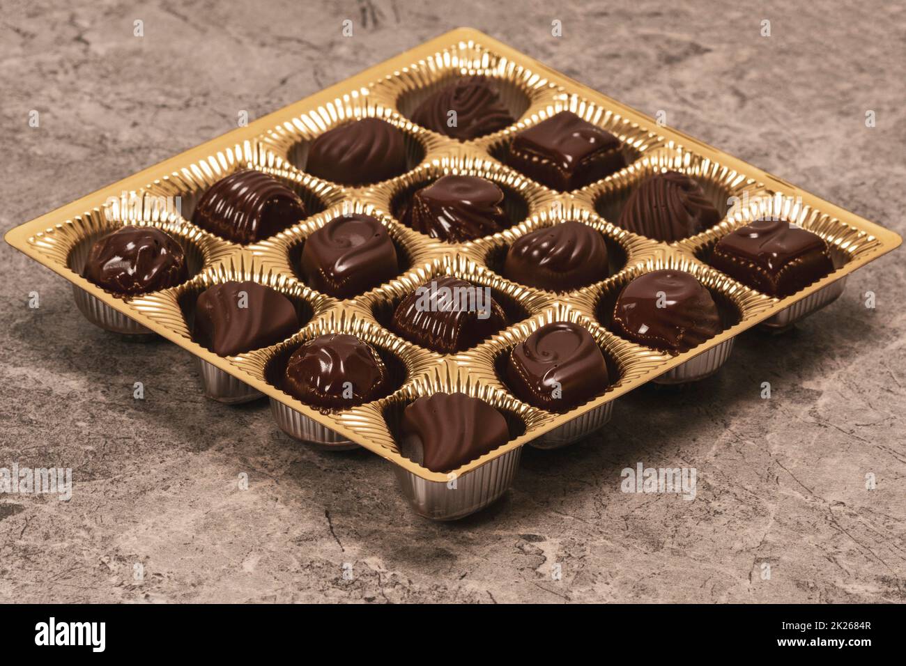 Assorted chocolates lying in a golden box Stock Photo Alamy