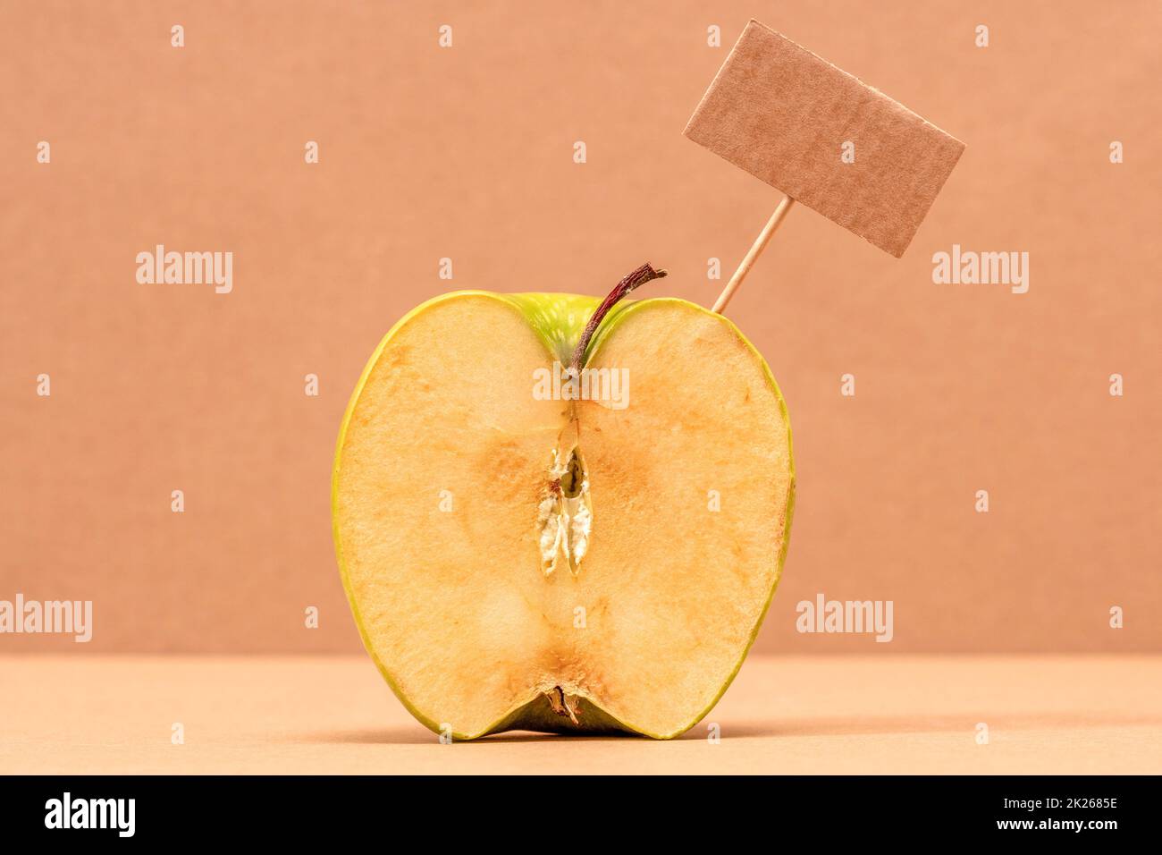 Green Apple with blank price tag or empty paper panel Stock Photo