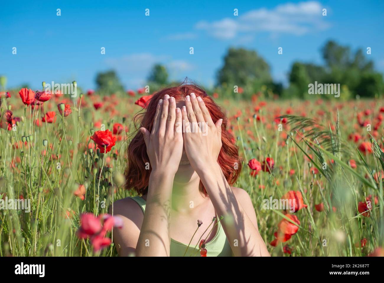 girl with red hairs covers her eyes Stock Photo Alamy