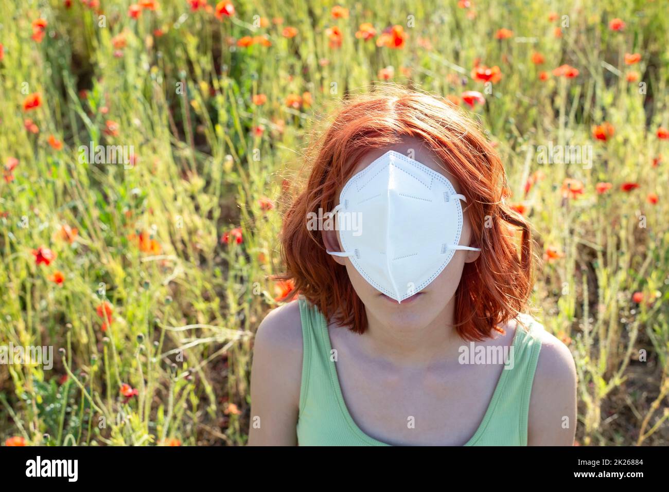 frustrated young girl with protective mask in front off face Stock Photo