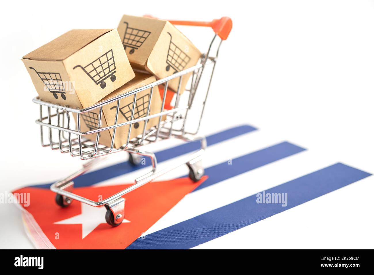 Box with shopping cart logo and Cuba flag, Import Export Shopping online or eCommerce finance delivery service store product shipping, trade, supplier concept. Stock Photo