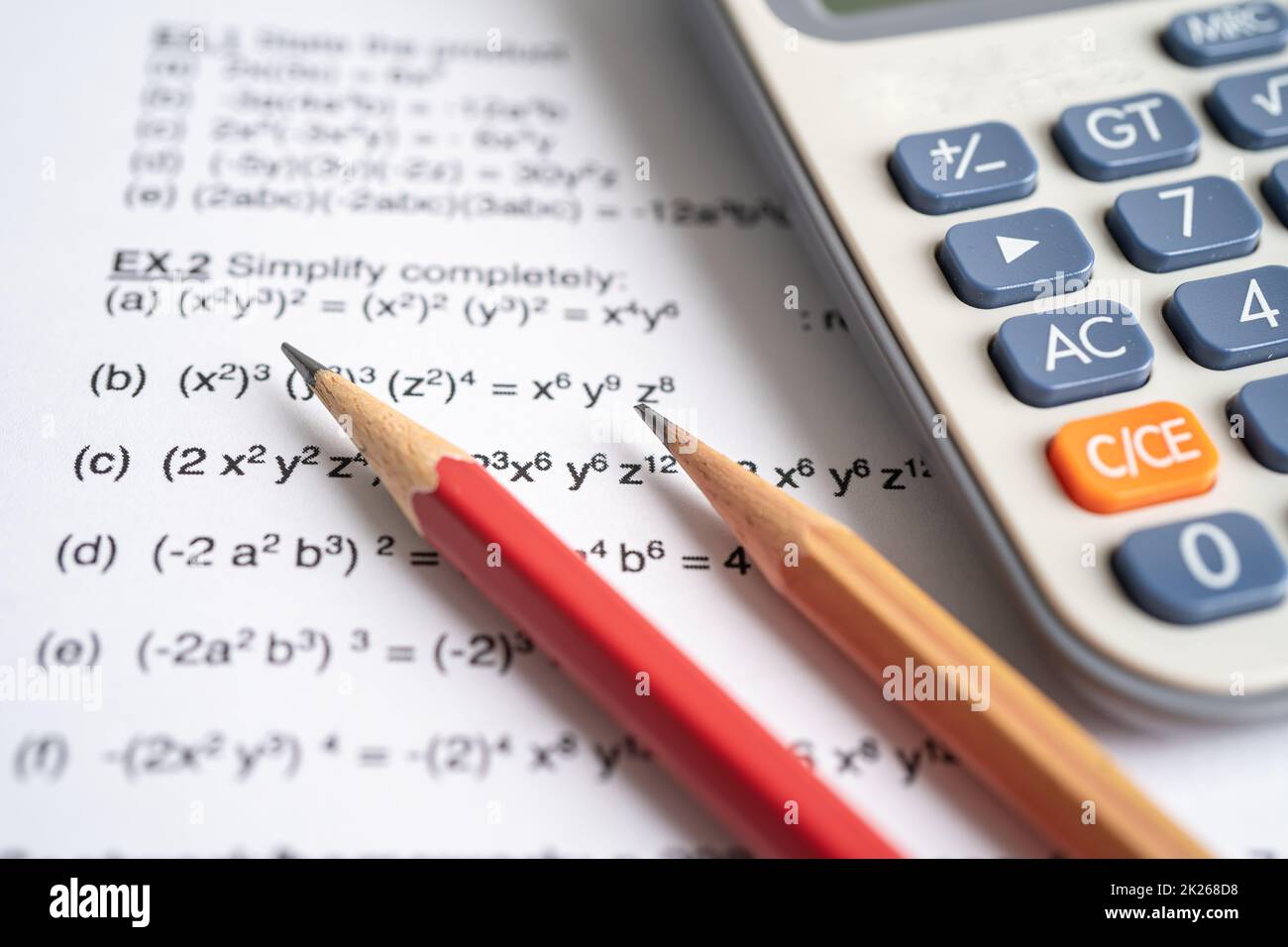 Pencil and calculator on mathematic formula exercise test paper in