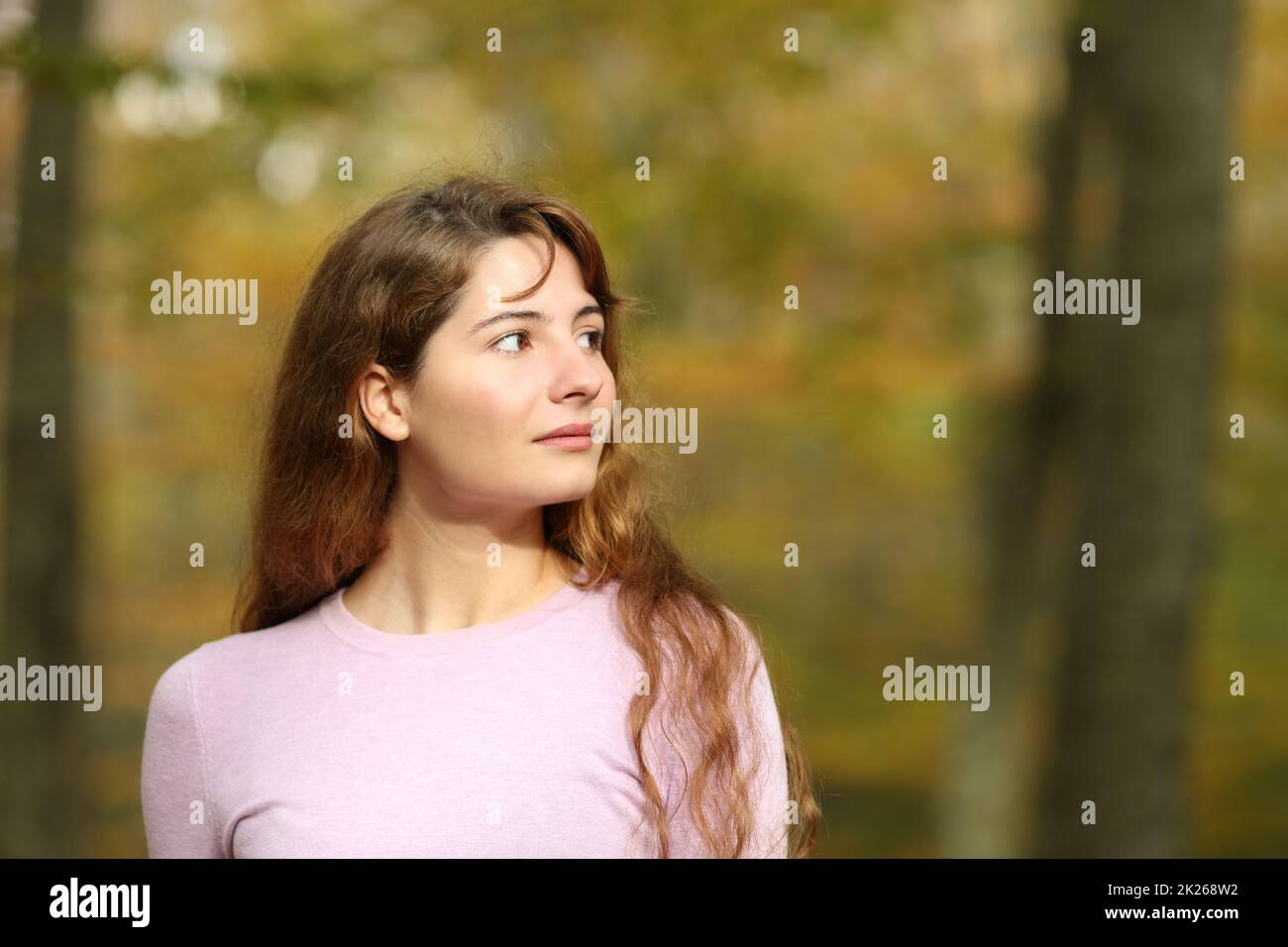 Woman looking at side walking in a park Stock Photo