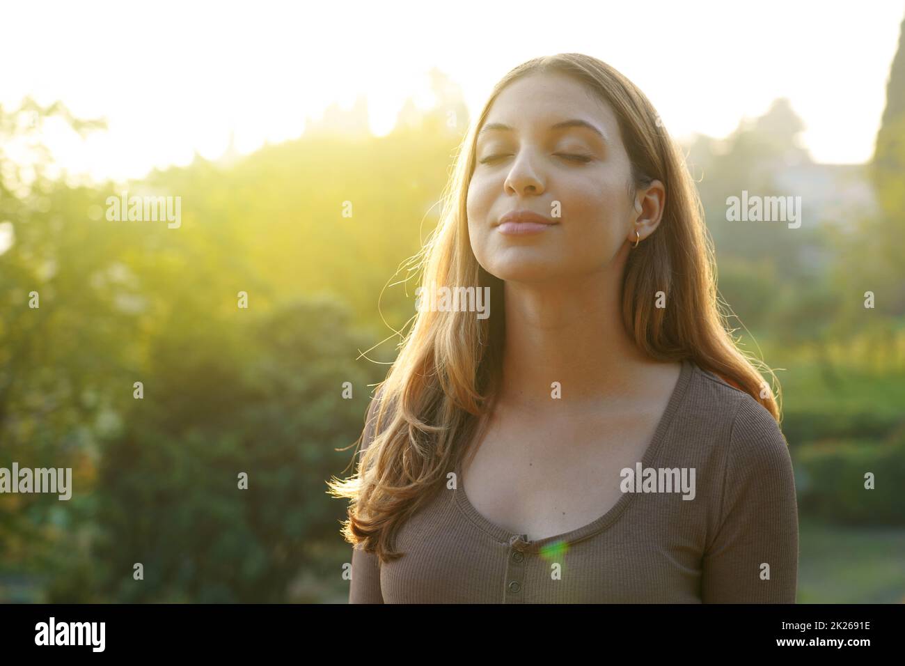 Portrait of beauty woman breathing fresh air against natural background. Copy space Stock Photo