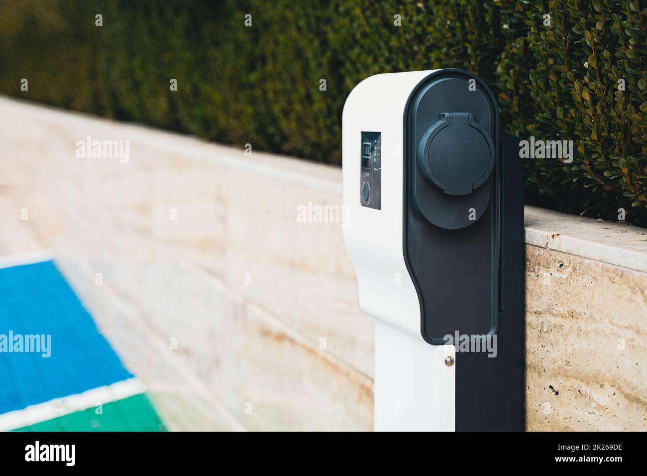 closeup of electric car charger in parking lot Stock Photo
