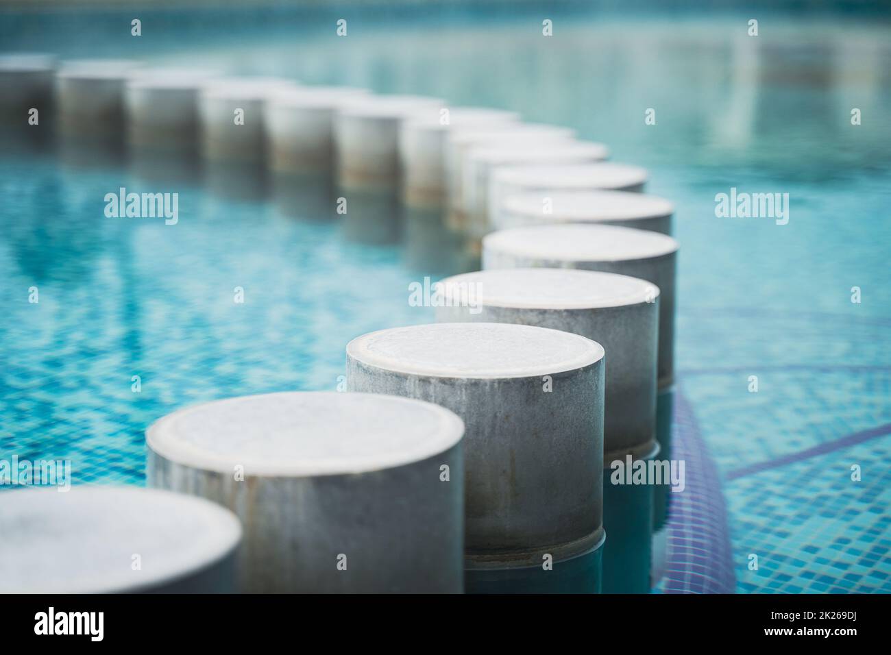 closeup of pool with decorative concrete pillars Stock Photo