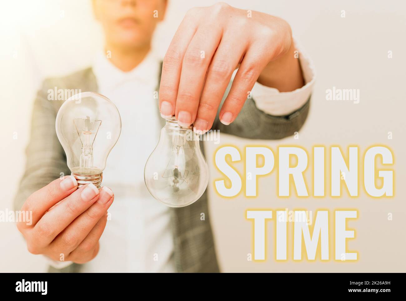 Writing displaying text Spring Time. Word Written on temperate season of the year identified by a revival of plants Lady outfit holding two lamps upside down presenting new technology ideas Stock Photo