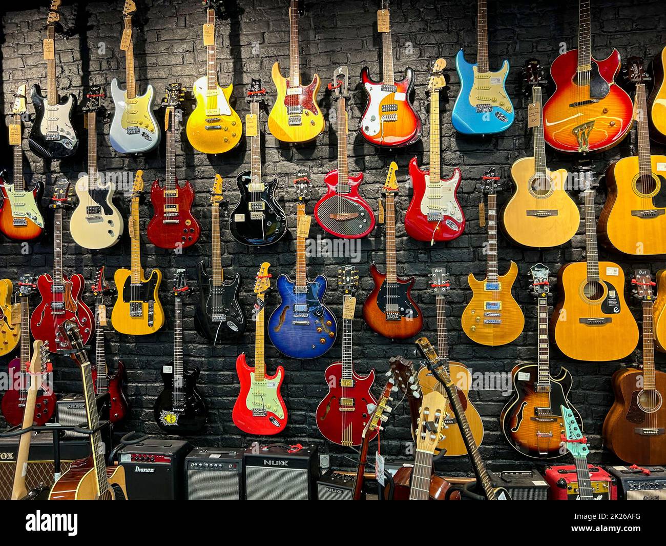 Paris, France, Collection Used Guitars Display on Wall, inside, Recycling Consumer Goods Store in Beaubourg Neighborhood 'Upcycling en Cours...' Stock Photo