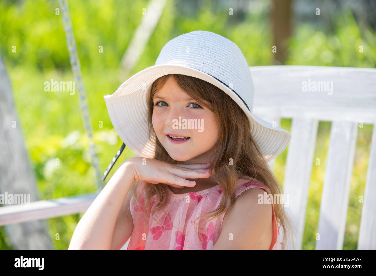 Teen girl outdoors, close-up. Portrait of attractive little teen with beautiful happy smiling face. Nature childhood leisure concept. Cute child. Stock Photo