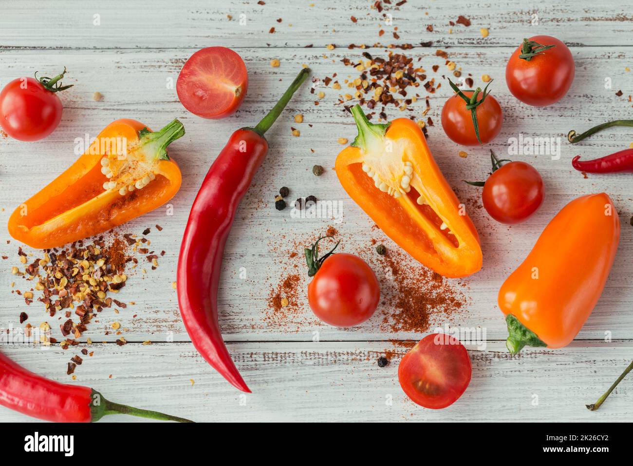 Assorted peppers, cherry tomatoes and spices on light background. Seasonings for food.  Stock Photo
