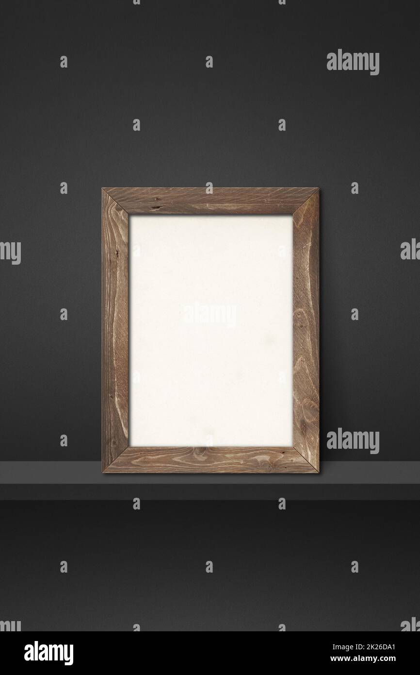 Wooden picture frame leaning on a black shelf. 3d illustration ...