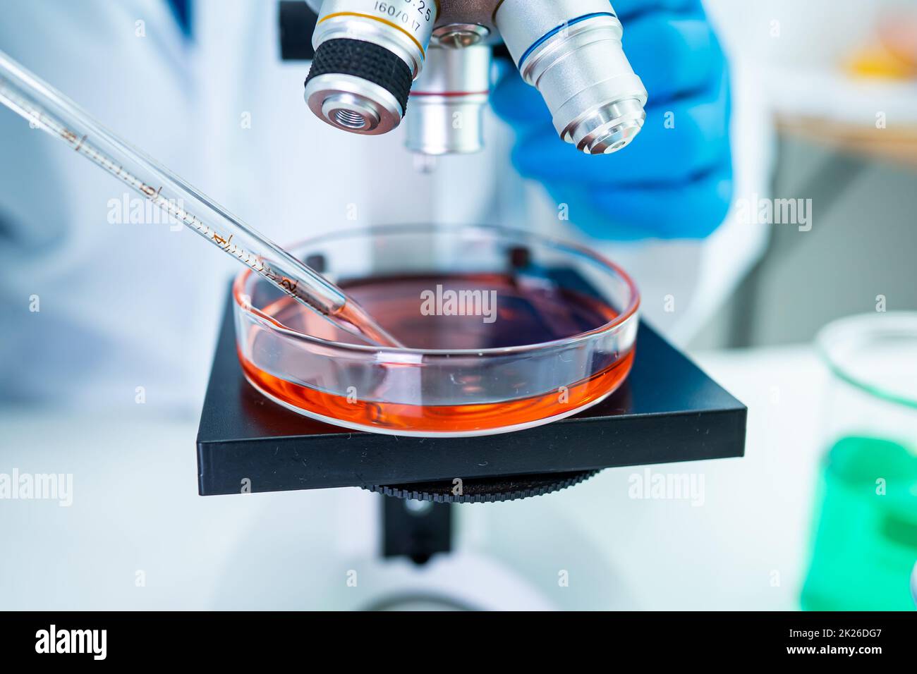 Asian scientist biochemist or microbiologist working research with a microscope in laboratory. For protect outbreak Coronavirus Covid19, bacteria and germs. Stock Photo