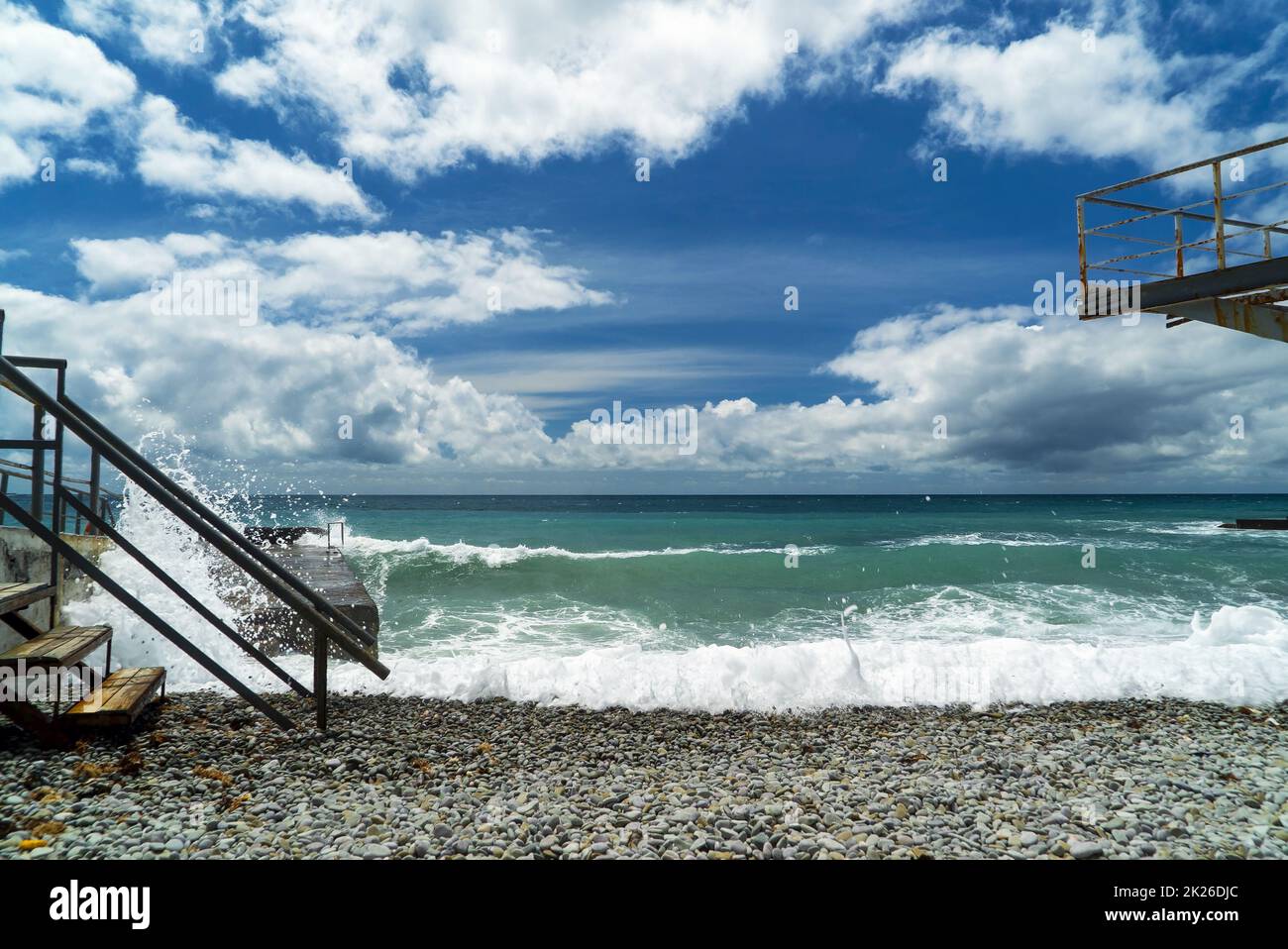 The sea is stormy. Large waves break on the breakwater .Crimea. Stock Photo