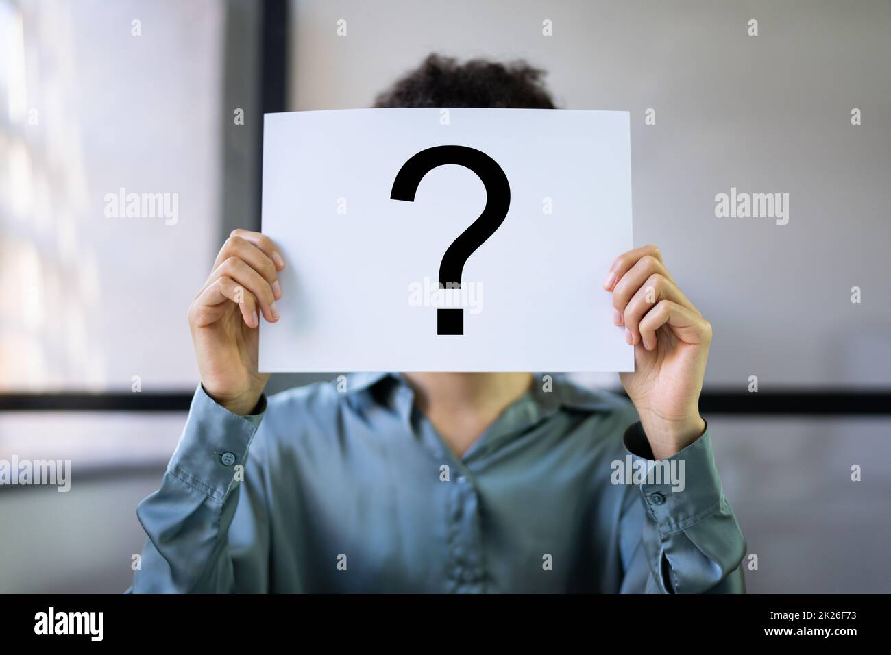 Businesswoman Holding Paper With Question Mark Stock Photo