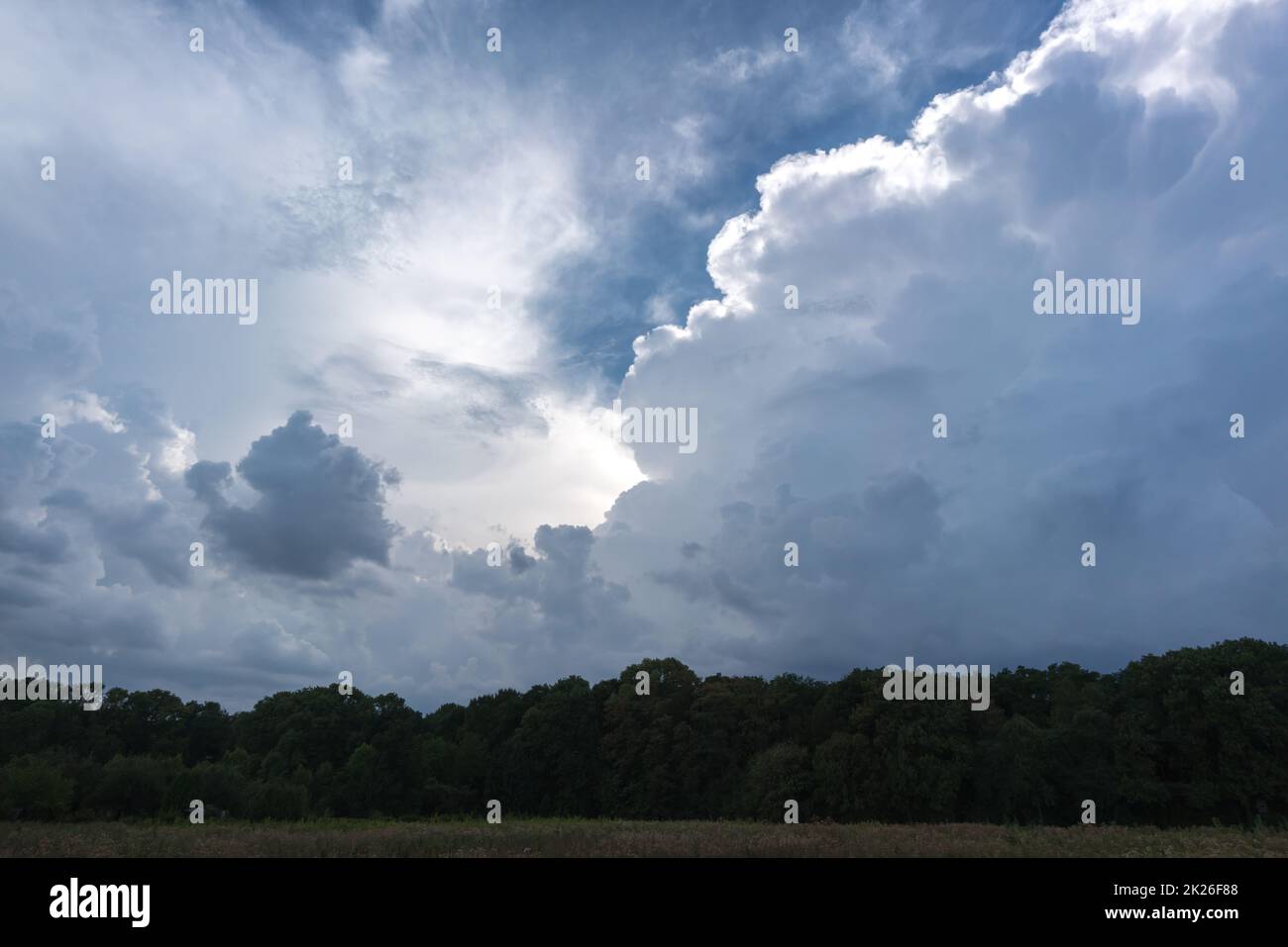 Large storm clouds over the countryside build up and bring wind and