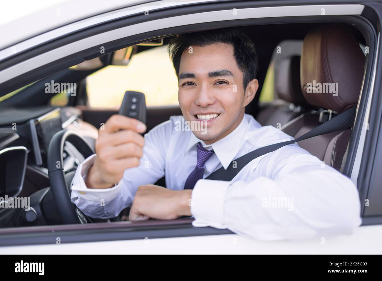 Business Man smiling and showing car keys Stock Photo - Alamy